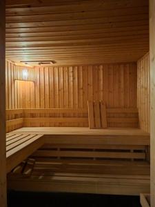a wooden sauna with a wooden bench in it at Apartament Bormio MarsMed in Biała Woda +4 photos