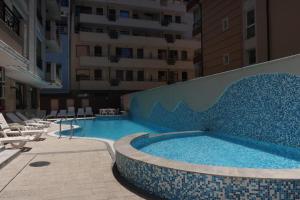 a swimming pool in the middle of a building at goldenseaview in Pomorie