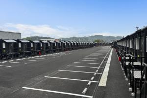 a row of train cars parked in a parking lot at HOTEL R9 The Yard Kurate in Nakama