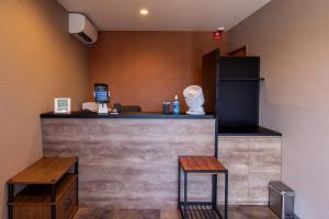 a bar with two tables and two stools at HOTEL R9 The Yard Kurate in Nakama