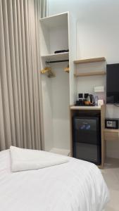 a bedroom with a white bed and a television at Tim in Riyadh +14 photos