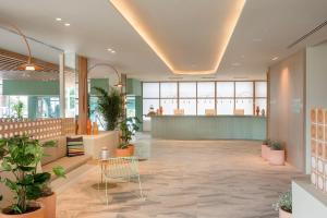 a lobby with a waiting area with plants at SOL by Meliá Arona Tenerife in Los Cristianos