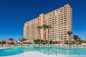a large building with a large swimming pool in front of it at SOL by Meliá Arona Tenerife in Los Cristianos