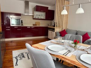 a kitchen and a dining room with a table at Ferienwohnung Stern, Natters in Innsbruck +7 photos