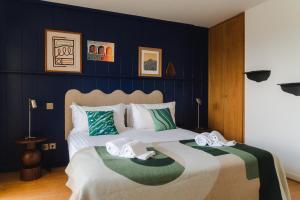 a bedroom with two beds with towels on them at APPARTEMENT PISCINE TERRASSE 1 MIN PLAGE et GOLF in Bidart