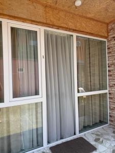 two sliding glass doors in a house at Hotel barbie Cottage #1-2 in Ureki