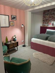 a bedroom with a bed and a desk and chairs at Chez Gaston in Spa
