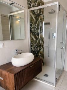 a bathroom with a sink and a shower at SottoSopra Tropea in Tropea +20 photos