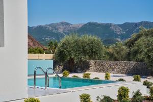 a view of a swimming pool with mountains in the background at Bella Terra Natura in Roda