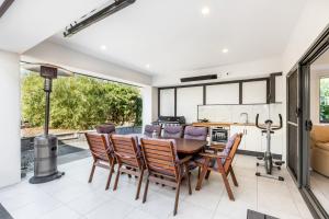 a kitchen and dining room with a table and chairs at Agathas at Seacombe Gardens in Sturt