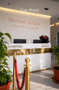 a sign for tim hotel with a red rope at Tim in Riyadh