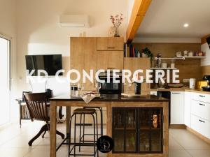 a kitchen with a table and chairs in a kitchen at L'ESCAPADE MARINE - face à la Mer in Port-de-Bouc