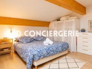 a bedroom with a bed with a blue comforter at L'ESCAPADE MARINE - face à la Mer in Port-de-Bouc