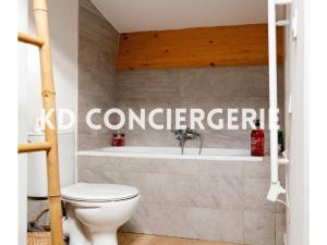 a bathroom with a toilet and a bath tub at L'ESCAPADE MARINE - face à la Mer in Port-de-Bouc