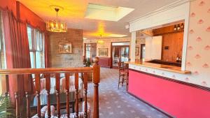 a kitchen with a bar in a house at The Columbia Hotel in Wellingborough
