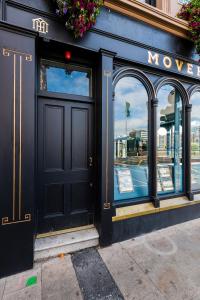 a store front with a black door and windows at Foxford penthouse in Foxford