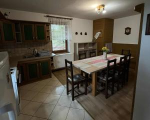 a kitchen with a wooden table and chairs in it at Chata Biely Potok in Oravský Biely Potok