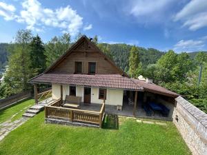 a small house with a roof on top of a yard at Chata Biely Potok in Oravský Biely Potok