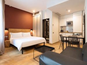 a bedroom with a bed and a living room at Aspasios Born in Barcelona