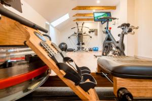 a gym with a treadmill and a exercise bike at Flair Hotel Rieckmann in Bispingen