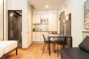 a small kitchen and dining room with a table and chairs at Aspasios Born in Barcelona