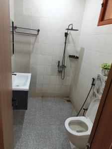 a bathroom with a toilet and a sink at Bbimo in Dakar +1 photo