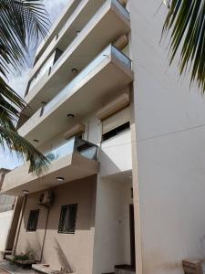 a building with balconies on the side of it at Bbimo in Dakar
