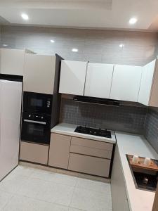 a kitchen with white cabinets and a stove top oven at Bbimo in Dakar