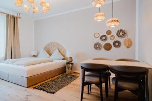 a bedroom with a bed and a table and chairs at Boho - Suites I BRIGHT-Collection in Koblenz