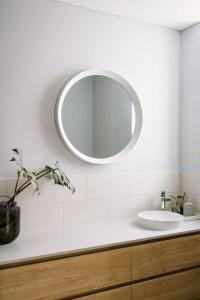 a white bathroom with a sink and a mirror at The Lookout, Albany Holiday House in Albany +44 photos