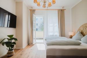 a bedroom with two beds and a large window at Boho - Suites I BRIGHT-Collection in Koblenz
