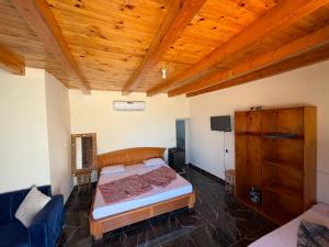 a bedroom with two beds and a wooden ceiling at Bonanza beach camp in Nuweiba