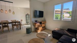 a living room with a couch and a table at Le Petit Vigneron in Nuits-Saint-Georges