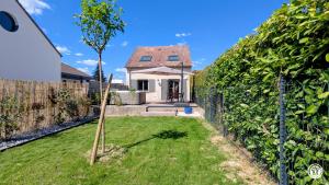 a garden with a fence and a house at Le Petit Vigneron in Nuits-Saint-Georges