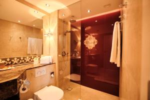 a bathroom with a toilet and a sink and a shower at Hotel Halm Konstanz in Konstanz +87 photos
