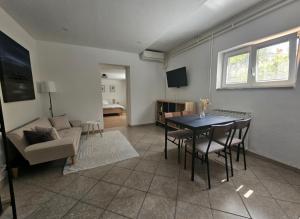 a living room with a table and a couch at Apartma Sofiora in Dekani