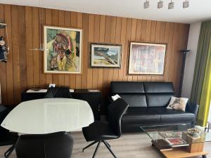 a living room with a couch and a table at FeWo bei Charly in Herrischried