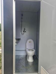 a small bathroom with a toilet in a stall at Hacienda Caravan in Szentes