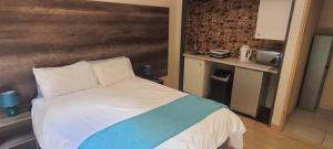 a bedroom with a large bed with a wooden headboard at The Crooked Forest in Pretoria