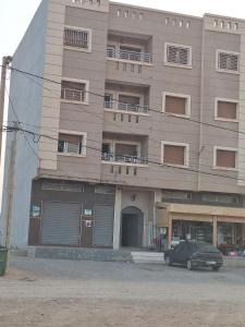 a building with a car parked in front of it at Lmadghri6 in Ras El Ma