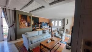 a living room with a couch and a table at Auberge Dar Najmat in Mirleft