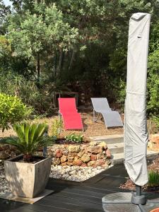 two chairs sitting next to a stone wall at Les Enganes in Fréjus