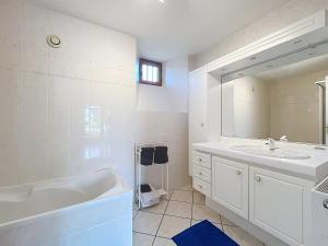 a white bathroom with a tub and a sink at Le Manoir du Butel in Saint-Amand +52 photos