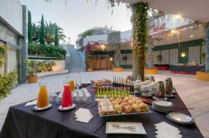a table with food and drinks on top at SOL by Meliá Port Cambrils in Cambrils