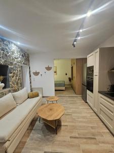 a living room with a couch and a table at Stay In Zia in Asfendioú
