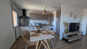 a kitchen and dining room with a table and chairs at Cozy apartment with exceptional view in Gex