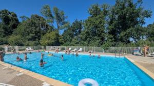a group of people in a swimming pool at Cozy apartment with exceptional view in Gex