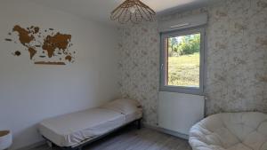a small room with a bed and a window at Cozy apartment with exceptional view in Gex