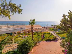 a group of people on the beach near the ocean at Elysium Elite Hotel in Kızılot