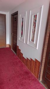 a hallway with two windows and a red carpet at Assala Hotel in Faisalabad